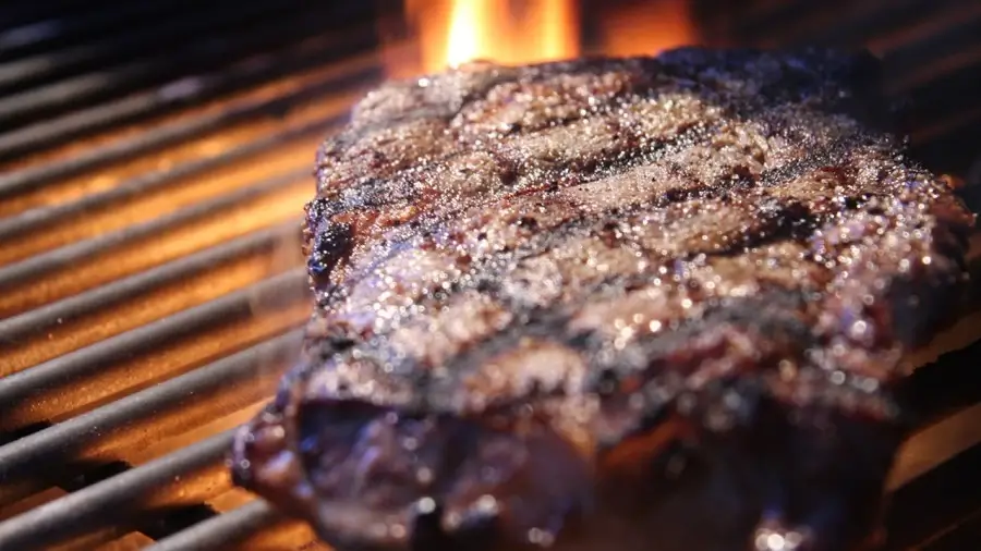 A delicious steak being grilled to perfection on a Hearthstone grill.