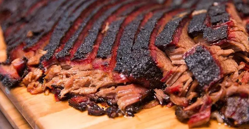 A perfectly cooked brisket being sliced for a gathering.